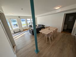 Living room with large sea-facing windows in a Type A apartment