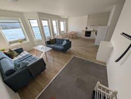 Living room with wraparound sea-facing windows in a Type B apartment